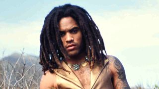 Lenny Kravitz posing for a photograph in a gold suit in 1991