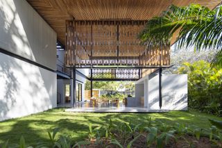 Lush green gardens and low pavilions at Naia retreat in Costa Rica