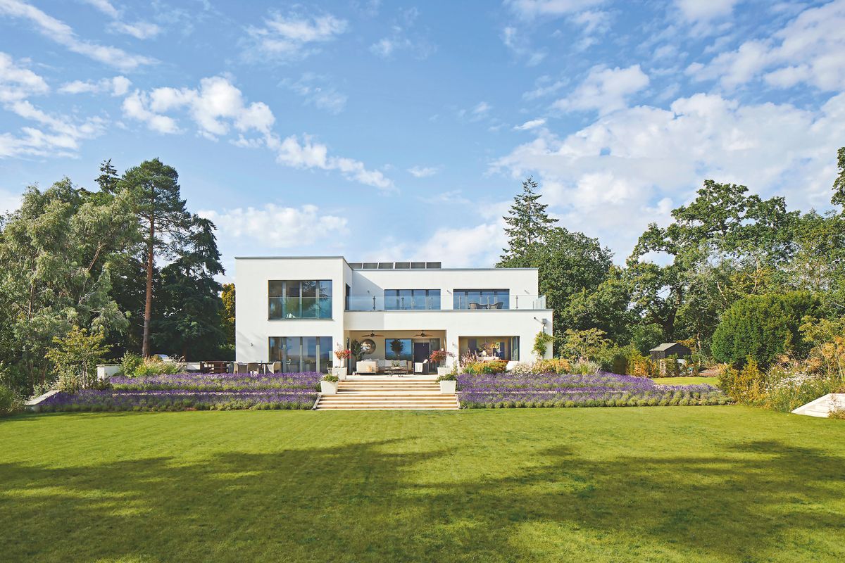 white modern self build with flat roof and garden