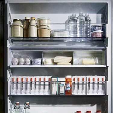 open refrigerator with food and medicine inside