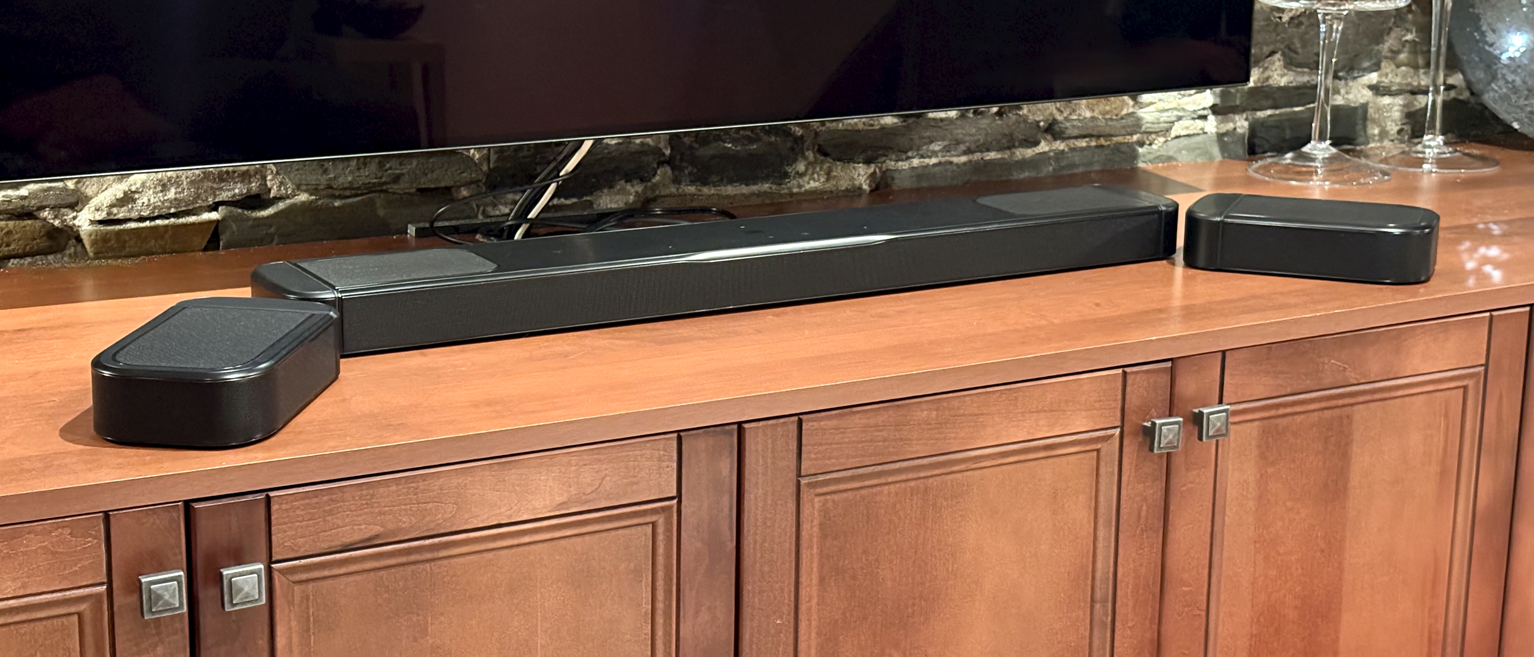 JBL Bar 1000MK2 on stand with surround speakers