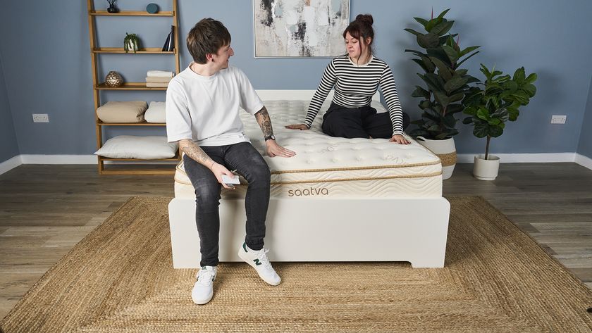 Our sleep deals writer and sleep features editor sit and chat on the Saatva Classic mattress during a testing panel session at our sleep studio