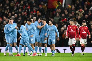 Nottingham Forest's Serbian defender #31 Nikola Milenkovic (C) celebrates after scoring his team first goal during the English Premier League football match between Manchester United and Nottingham Forest at Old Trafford in Manchester, north west England, on December 7, 2024.