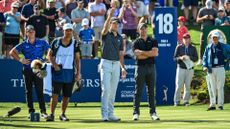 Rory McIlroy of Northern Ireland reacts and speaks to Jordan Spieth about where his tee shot crossed into the water on the 18th hole during the first round of THE PLAYERS Championship on the Stadium Course at TPC Sawgrass 