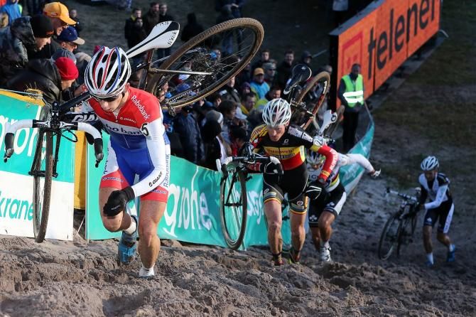Racers climb up a sandy hill