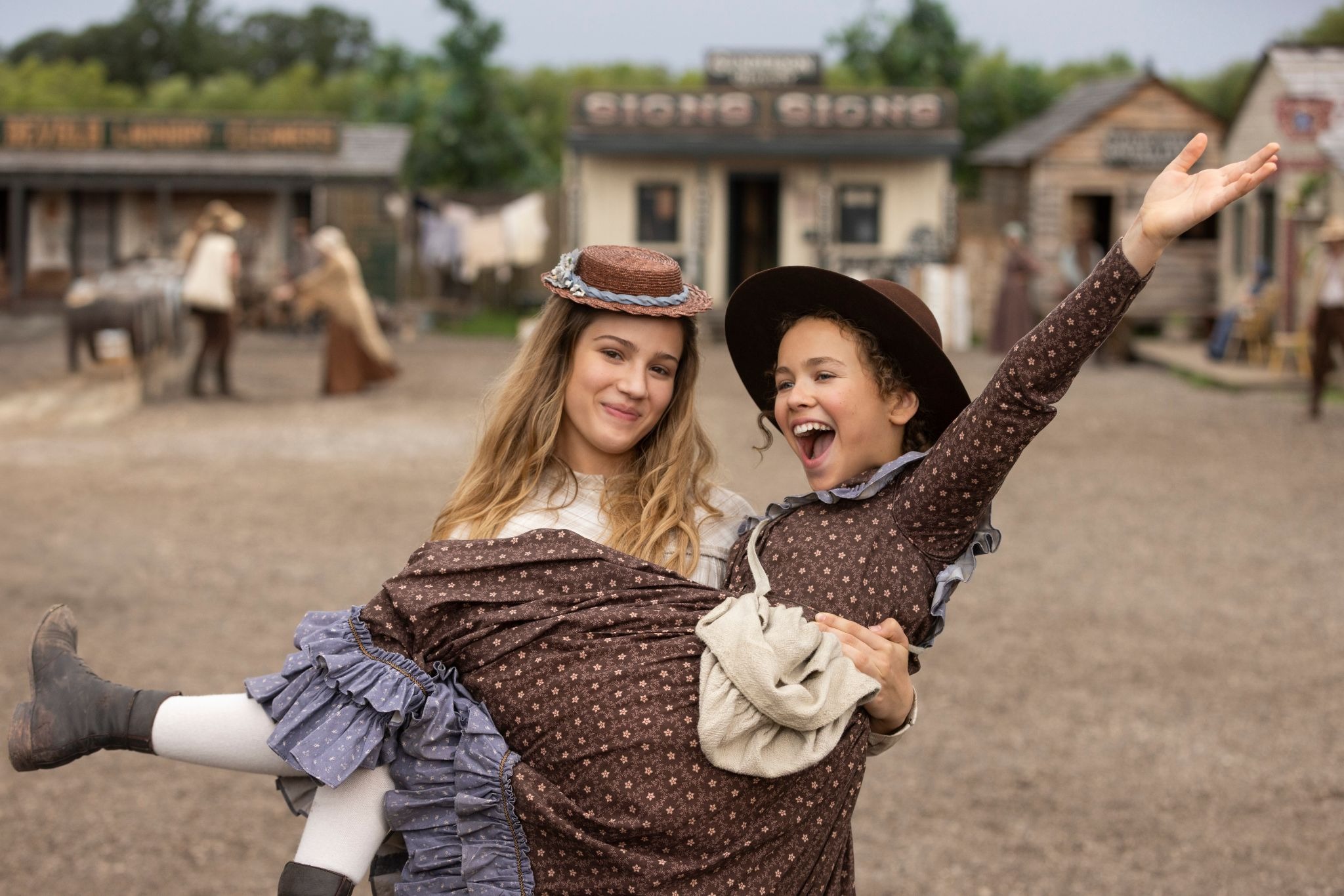 one star of little house on the prairie lifts up another as they celebrate the end of production wrapping on season 2