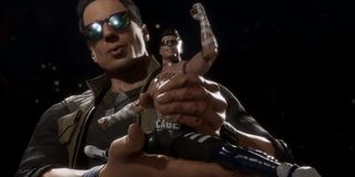 Johnny Cage holding a mini Johnny Cage in Mortal Kombat 11