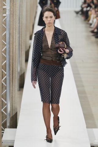 Miu Miu fall/winter 2024 runway model wearing a polka dot skirt set