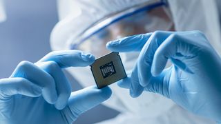 A chip technician examining a semiconductor chip