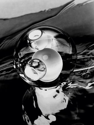 Black and white photograph of a table lamp by Omer Arbel for Bocci
