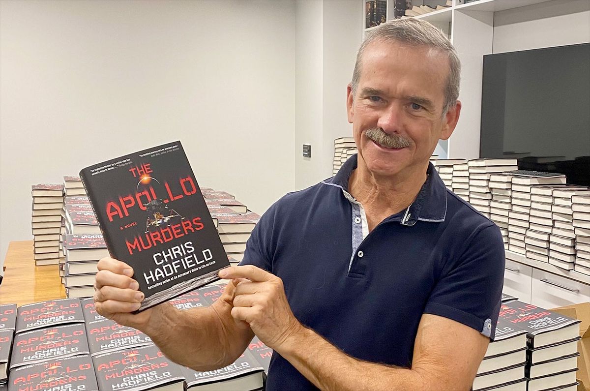 Chris Hadfield, former Canadian Space Agency astronaut, holds up a copy of his first novel, &quot;The Apollo Murders.&quot;