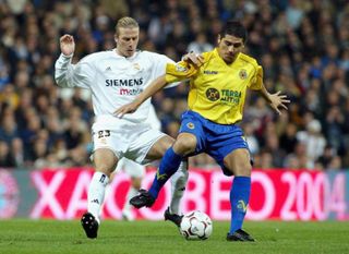Villarreal's Juan Roman Riquelme holds off Real Madrid's David Beckham in a La Liga game in 2004.