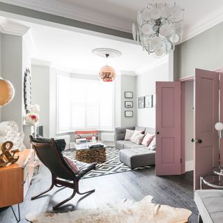 living room with pink door and sofa