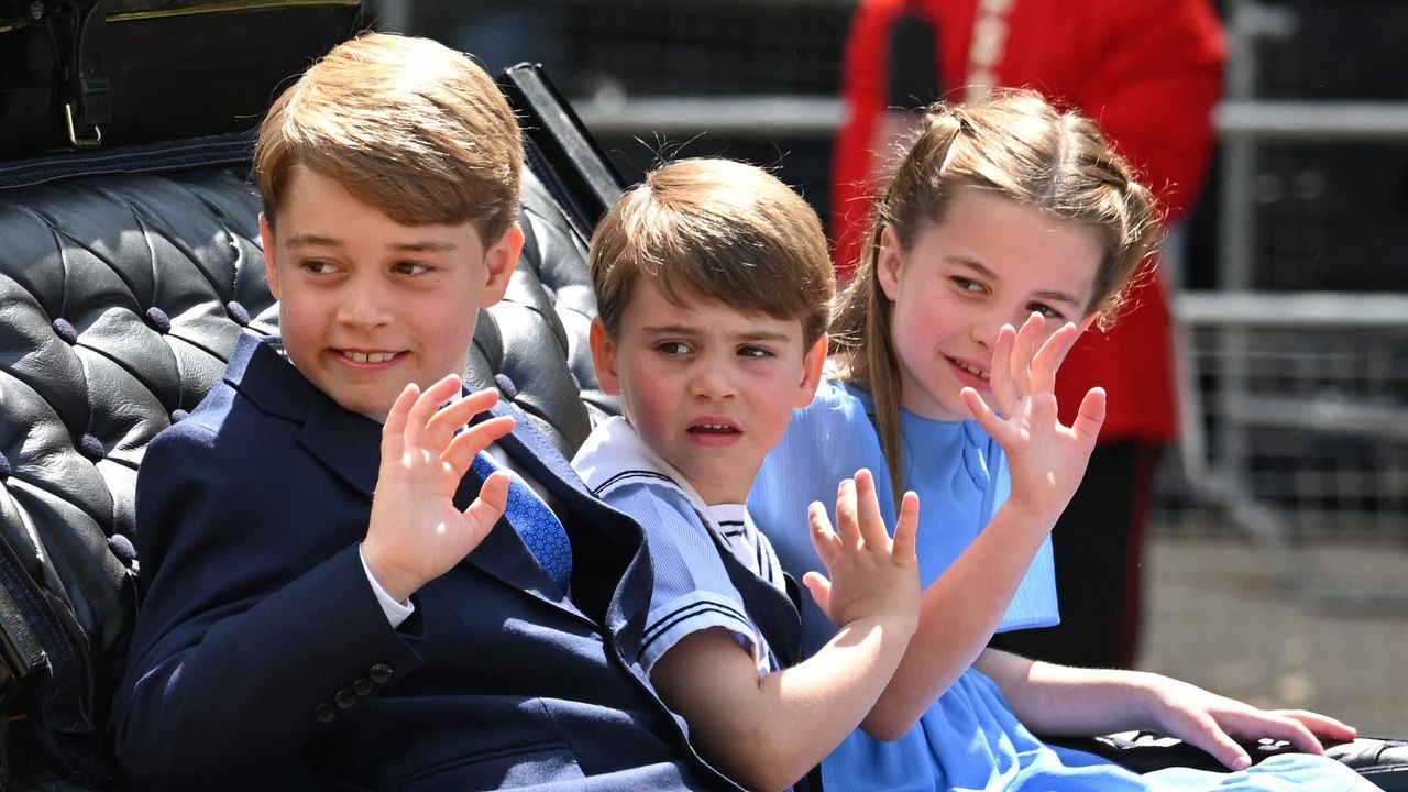 Prince George, Princess Charlotte and Prince Louis wave from a carriage at Trooping the Colour