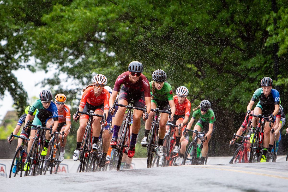 The peloton rounds a corner in the rain during the US Pro Criterium