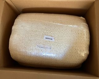 Turmerry latex mattress topper in cardboard box