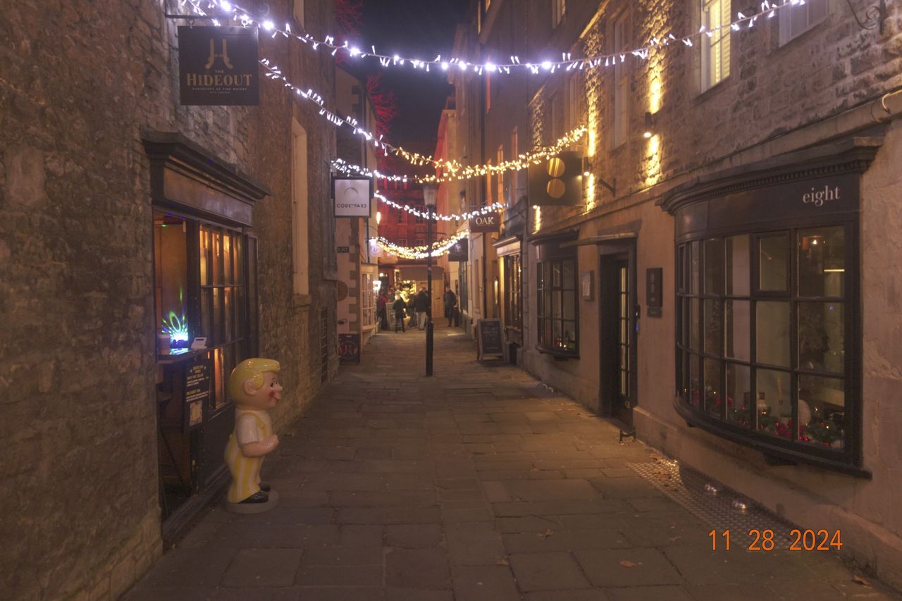 Night street scene in the city of Bath, UK, with retro photo picture effect