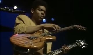 Stanley Jordan performs onstage, with two guitars