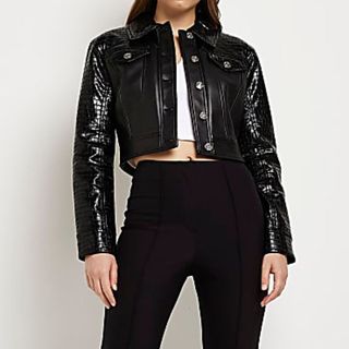 model wearing a river island cropped black trucker style leather jacket