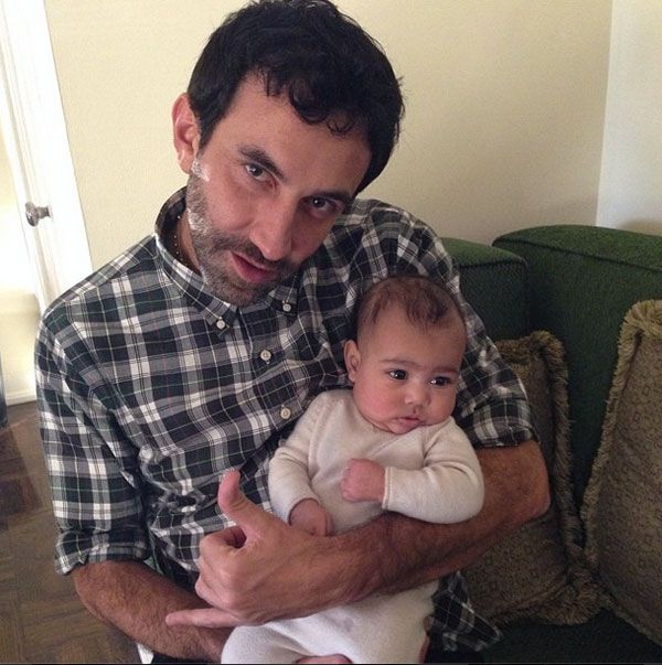 North West wearing pastel-colored cashmere held by Riccardo Tisci
