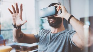 A person reaching out a hand excitedly while in VR