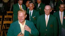 Jack Nicklaus (L) presents the green jacket to himself as a consecutive winner alongside Clifford Roberts (R) during the Presentation Ceremony at the 1966 Masters Tournament at Augusta National Golf Club held April 7-11, 1966