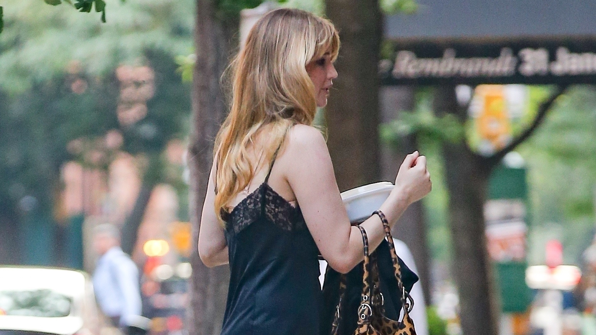 Jennifer Lawrence channels lingerie dressing in a lacy black slip dress and house slippers.