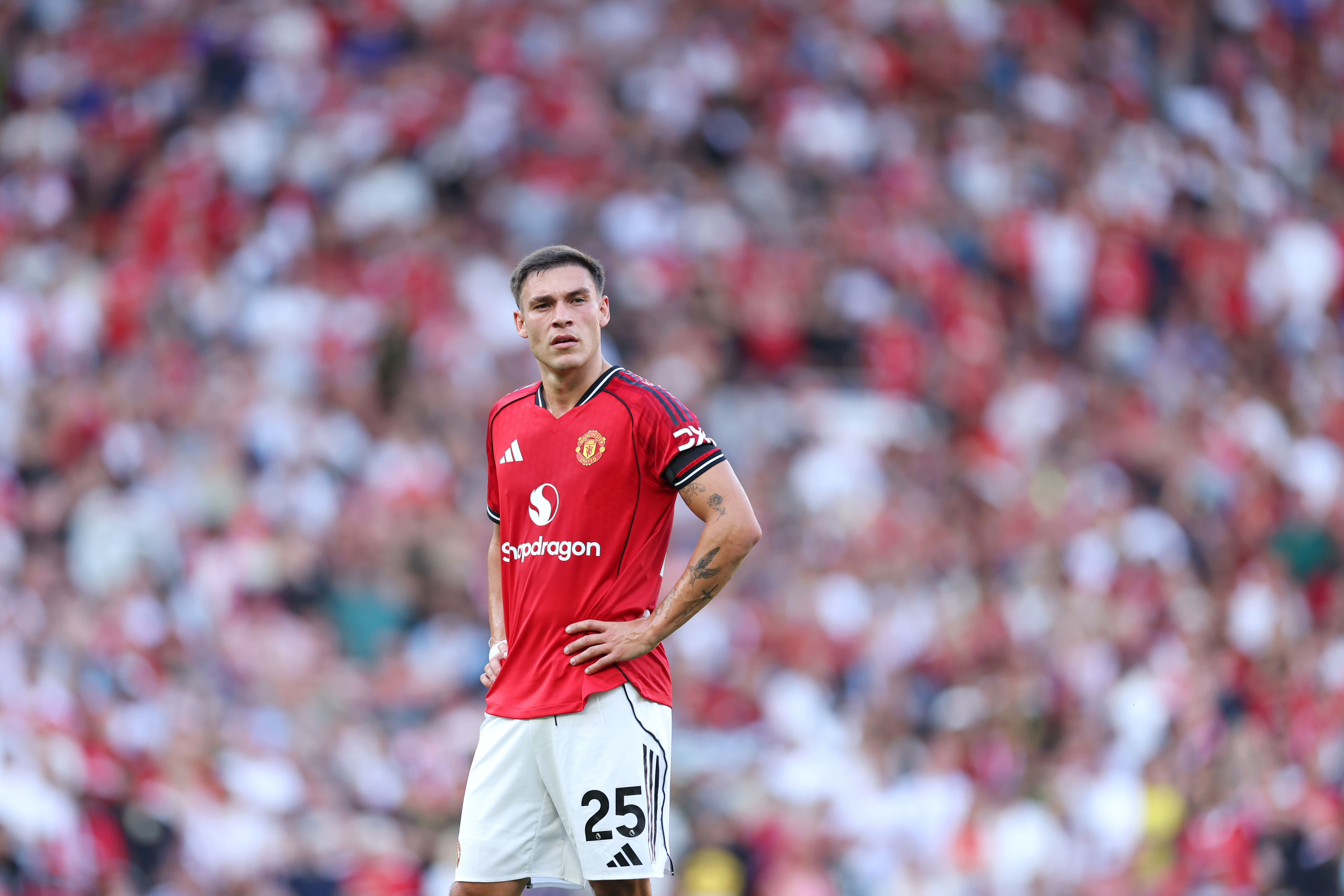 Manuel Ugarte stands with hands on hips after Man United lose to Arsenal