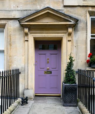 Purple front door on light stone period property