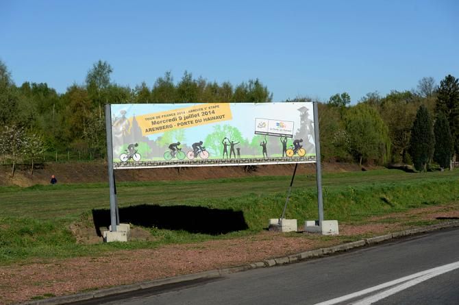 A sign directs the way to the Arenberg cobbles