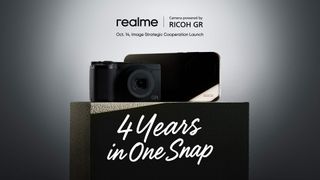 A compact digital Ricoh GR camera next to a mystery Realme smartphone in the shadows