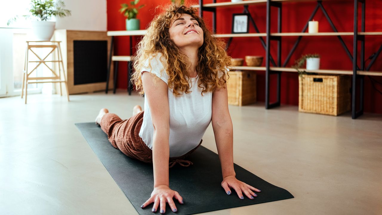 Smiling woman in cobra pose