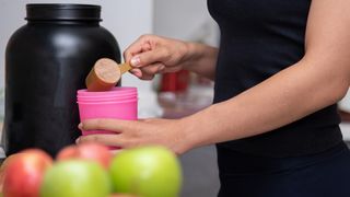 Best vegan protein powder: Woman making a protein shake