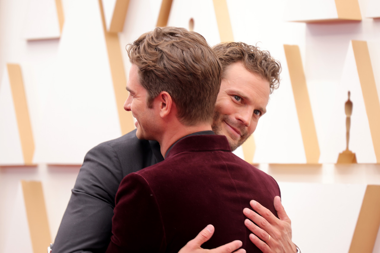 Jamie Dornan and Andrew Garfield hugging at the Oscars 2022 red carpet