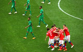Russia's players celebrate after Aleksandr Golovin's goal to make it 5-0 against Saudi Arabia in the opening match of the 2018 FIFA World Cup on 14 June in Moscow, Russia