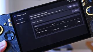 Handheld ROG Ally held in hand, displaying the Update Center screen with a preview update for the AMD Radeon Graphics Driver version 32.0.32015.7029.