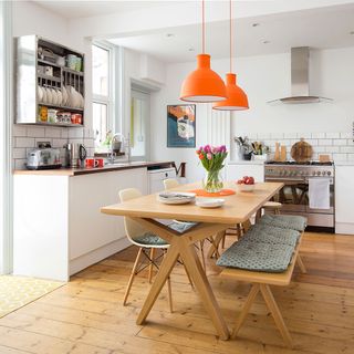 kitchen with white wall and wooden table