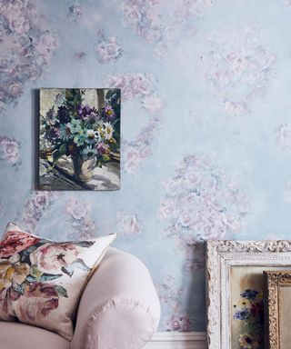 Blue living room with pink floral decoupage, pink couch, artwork