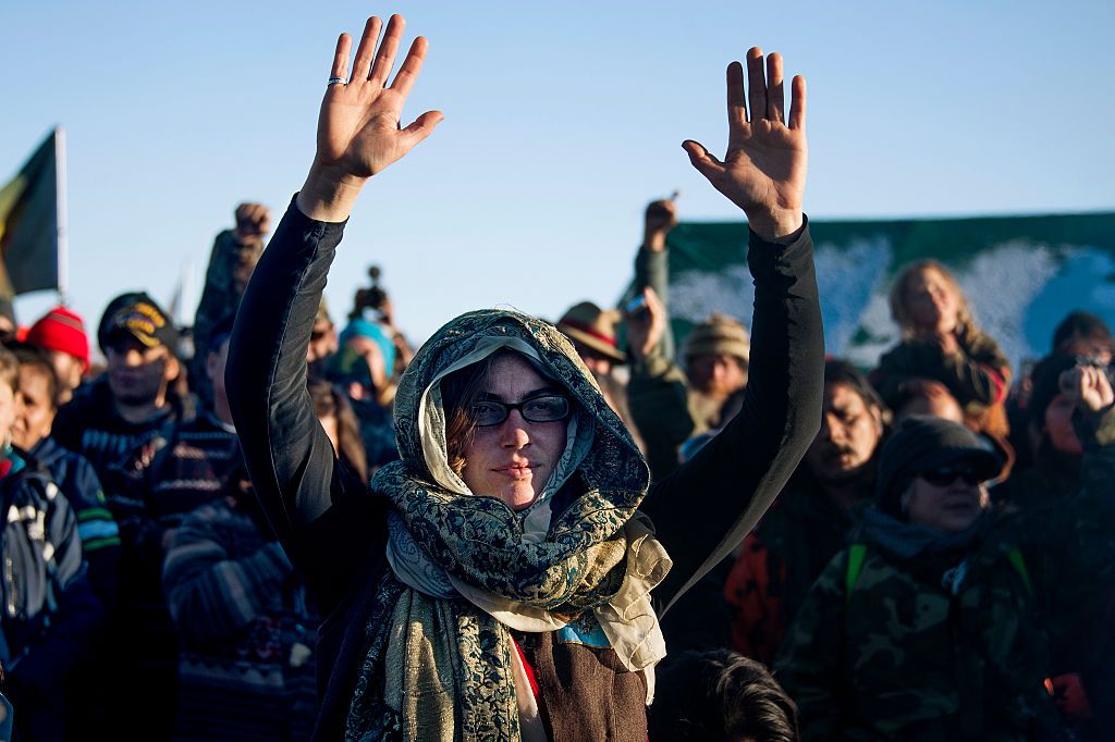 Activists celebrate at Oceti Sakowin Camp on the edge of the Standing Rock Sioux Reservation on December 4, 2016 outside Cannon Ball, North Dakota, after hearing that the Army Corps of Engine