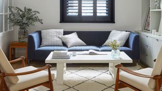 SMALL LIVING ROOM WITH EBLUE SOFA AND BERBER RUG