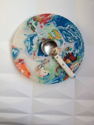 Marble-like colorful bowl with a measuring spoon.