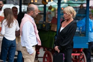 Teddy Mitchell taking to Sharon Watts in the market