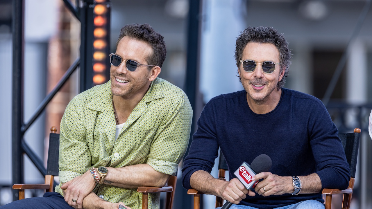 Ryan Reynolds and Shawn Levy smiling in sunglasses while promoting Deadpool & Wolverine. 