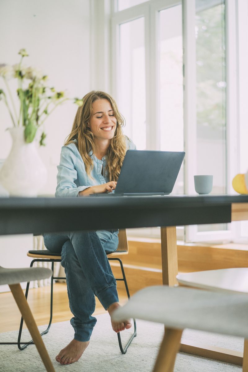 A woman using a laptop at a desk