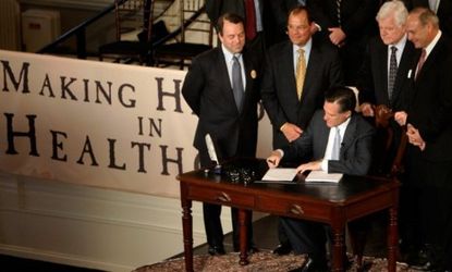Then-Governor Mitt Romney signs his health-care reform bill April 12, 2006