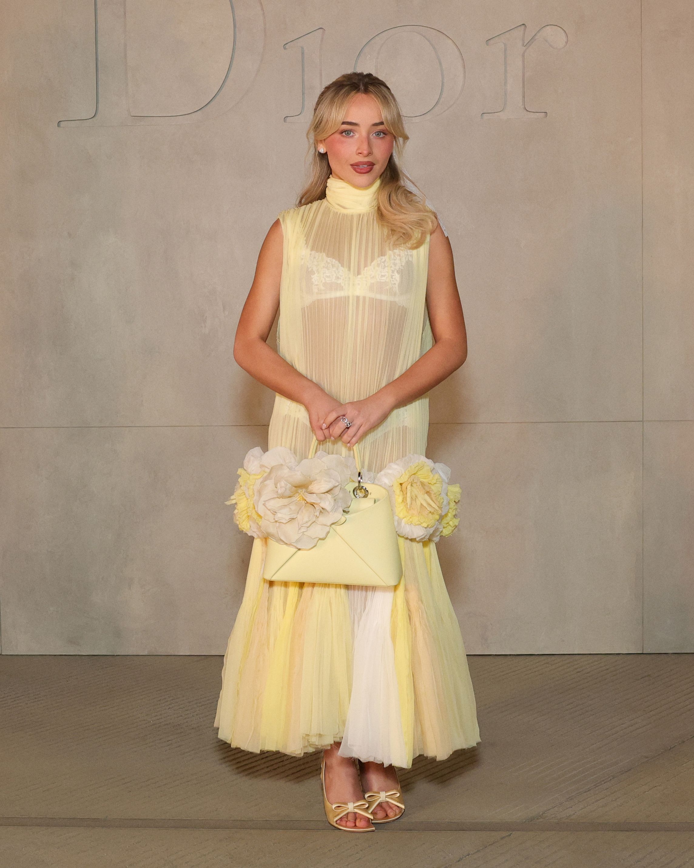 Sabrina Carpenter attended the Dior Cruise 2027 show in a butter yellow dress that debuted later on the runway
