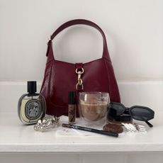 Shloka Narang Sensarma’s handbag with beauty products.