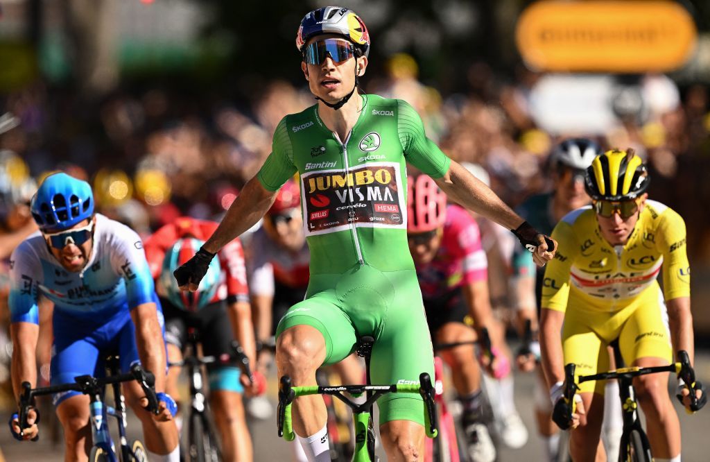 JumboVisma teams Belgian rider Wout Van Aert C celebrates as he cycles to the finish line to win the 8th stage ahead of Team BikeexchangeJayco teams Australian rider Michael Matthews L and UAE Team Emirates teams Slovenian rider Tadej Pogacar R during the 109th edition of the Tour de France cycling race 1863 km between Dole in eastern France and Lausanne in Switzerland on July 9 2022 Photo by Marco BERTORELLO AFP Photo by MARCO BERTORELLOAFP via Getty Images