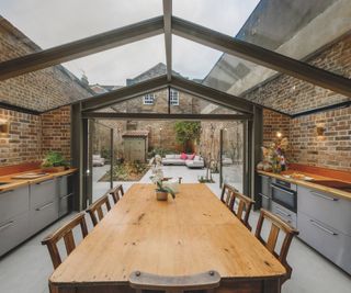 A pitched roof kitchen extension with a glass roof and steel beams