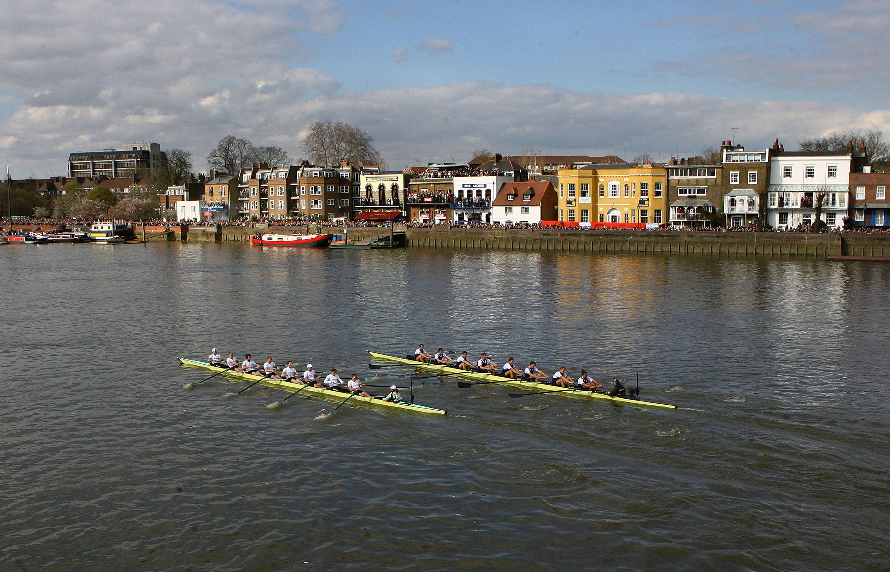 The Cambridge University (L) and Oxford University (R) Boat Race teams row up the River Thames near Hammersmith Bridge during the 155th Oxford &amp; Cambridge University Boat Race.